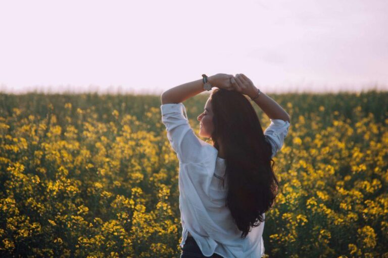 Woman Stands in Flower Field